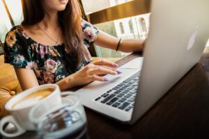 woman using public wi-fi on her laptop in a coffee shop